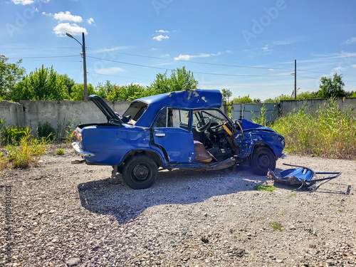 Road car accident. The car crashed. The car damege. The wheel came off. Broken minibus. Overturned car.  The car overturned. The car rolled over onto its roof.  photo