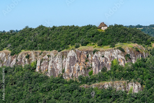 La chapelle Saint Victor au loin dominant la vallée de Massiac dans le Cantal avec ses falaises de rochers et ses belle forets verdoyantes photo