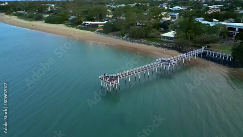 Drone View of Scarness Jetty in Hervey Bay, Qld Australia. Drone move around pier in late afternoon light.  photo