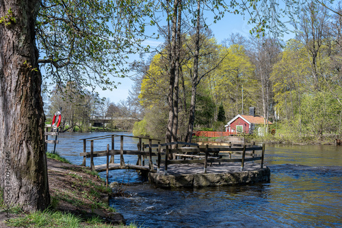 View from waterfront park Åbackarna towards the historic bridgekeepers cottage during spring in Norrköping.  Norrköping is a historic industrial town in Sweden.