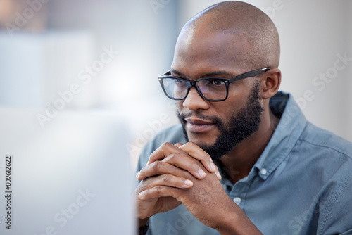 Black man, thinking and work or office for business, employee and online research for company on internet tech. Reading, thoughtful and planning for corporate, problem solving and idea in workplace
