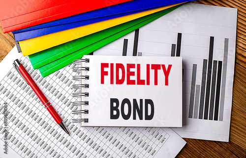 Canvas Print FIDELITY BOND text on notebook with folder on chart