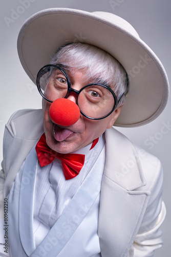 Clown sticking out his tongue with a sly expression on his face.