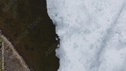 Ice Covered Surface Of Palvatnet Lake In Leknes, Vestvagoy, Nordland, Norway. - aerial overhead shot photo