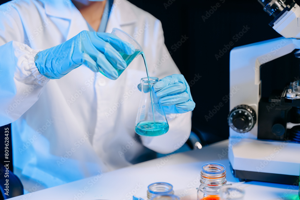 Fototapeta premium Female biotechnologist testing new chemical substances in a laboratory..