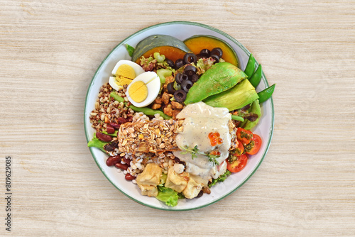 Healthy food salad plate on wooden background, top view.