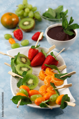 Fruit skewers with chocolate and mint.