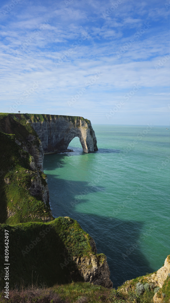 Cliffs, landscape along the Falaise d'Aval, view of the La Manche. Etretat, Normandy, France, English Channel. Natural rocks, coast. Rocks of the village of Etretat in spring in cloudy weather Cliffs, landscape along the Falaise d'Aval, view of the La Manche. Etretat, Normandy, France, English Channel. Natural rocks, coast. Rocks of the village of Etretat in spring in cloudy weather