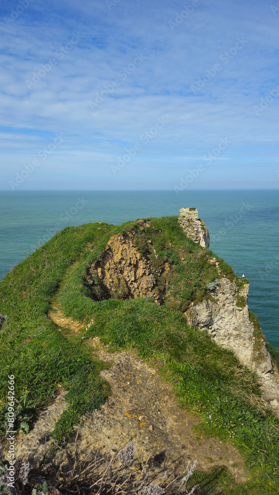 Cliffs, landscape along the Falaise d'Aval, view of the La Manche. Etretat, Normandy, France, English Channel. Natural rocks, coast. Rocks of the village of Etretat in spring in cloudy weather Cliffs, landscape along the Falaise d'Aval, view of the La Manche. Etretat, Normandy, France, English Channel. Natural rocks, coast. Rocks of the village of Etretat in spring in cloudy weather