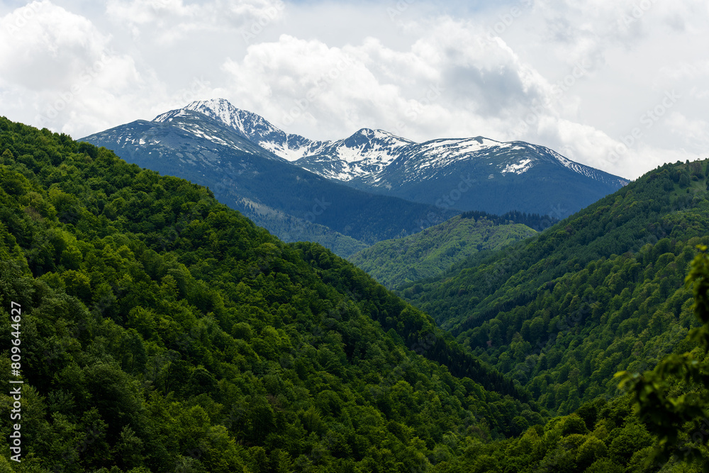 Snowy peaks of Retezat Mountains in Transylvania, Romania, seen from a hill top Snowy peaks of Retezat Mountains in Transylvania, Romania, seen from a hill top