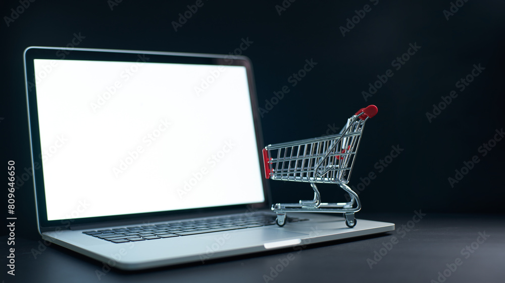 Online shopping concept with laptop and cart Online shopping concept with laptop and cart