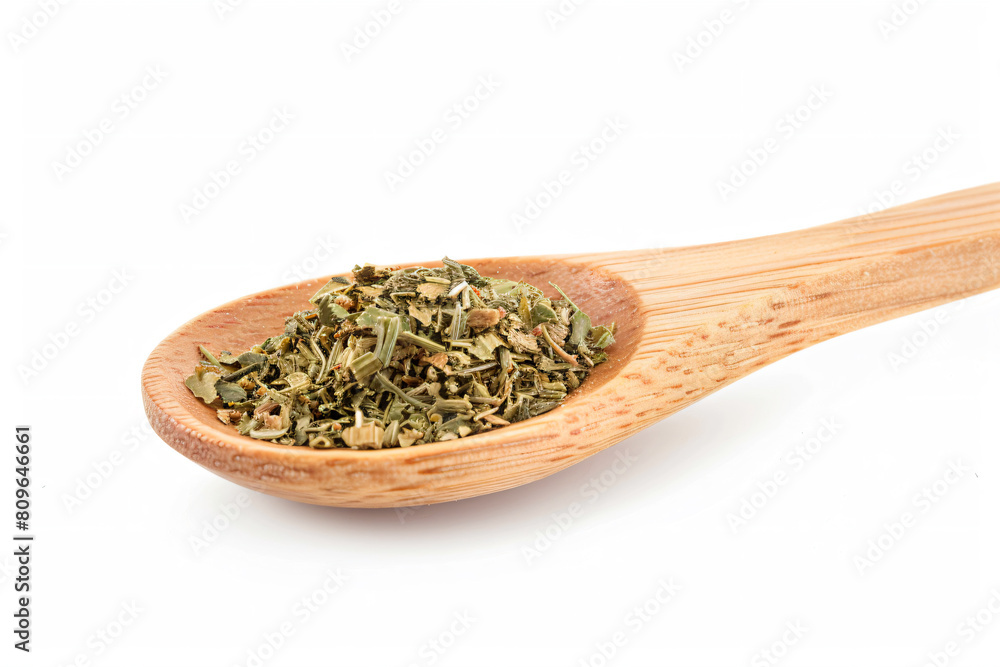 a wooden spoon filled with dried herbs on a white surface a wooden spoon filled with dried herbs on a white surface