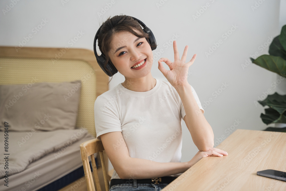 Portrait of beautiful young Asian girl at home