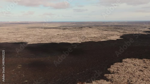 Barren inhospitable volcanic rock landscape, endless empty plain. photo
