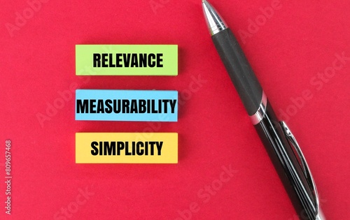 colored pen and paper with the words relevance, measurability and simplicity. 3 aspects do KPIs measure. photo