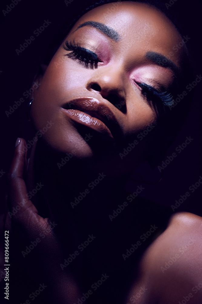 Beauty, face and glamour with black woman in makeup on dark background for cosmetics or elegance. Eyeshadow, lipstick and mascara with bold model person in studio for african pride or art deco Beauty, face and glamour with black woman in makeup on dark background for cosmetics or elegance. Eyeshadow, lipstick and mascara with bold model person in studio for african pride or art deco