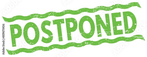 POSTPONED text on green lines stamp sign. photo