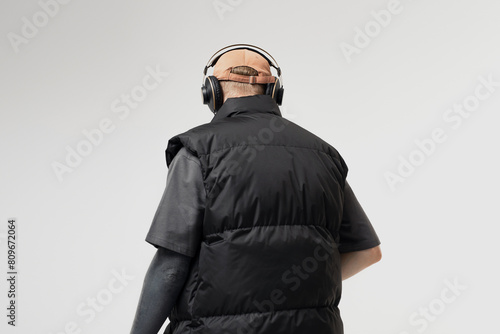 Young man in headphones on a white background photo from the back photo