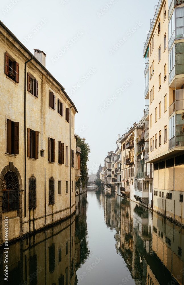 The city canal San Massimo in Padua. Beautiful urban view of residential buildings with balconies in the center of the old city Padova, Veneto. Rivers Brenta and Bacchiglione, Italy