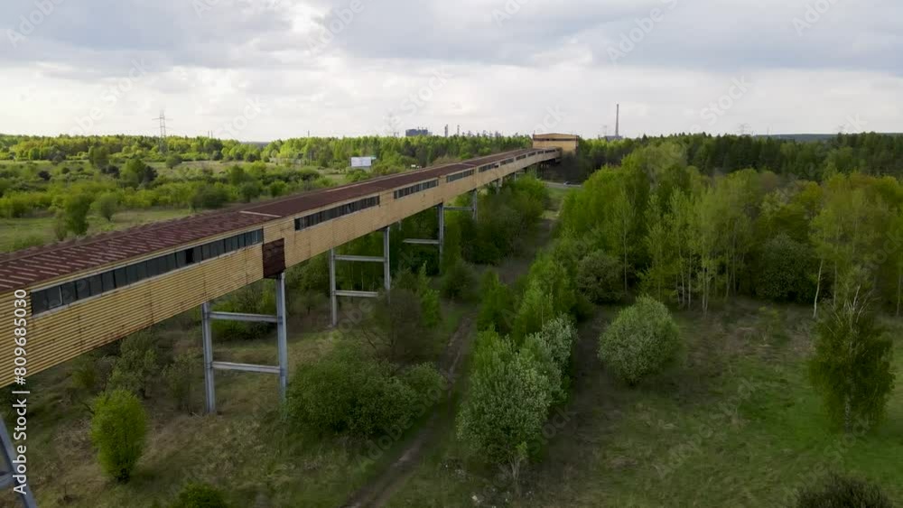 Long tunnel bridge connecting huge factory in a far distance in eastern European or Russian looking like location