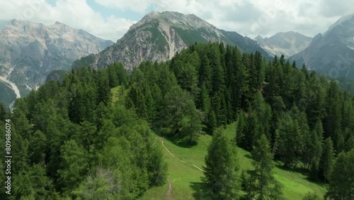 Aerial footage of a drone flying above a forest, a meadow and a mountain hut in the area of Crucs da Rit and Utia da Rit near the village of La Val, South Tyrol, Dolomites, Italy. LuPa Creative.