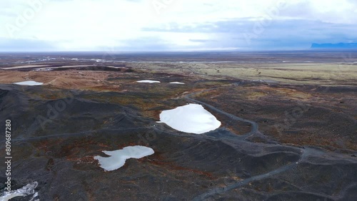 Barren volcanic landscape with glacial lakes and basalt hills, Iceland. photo