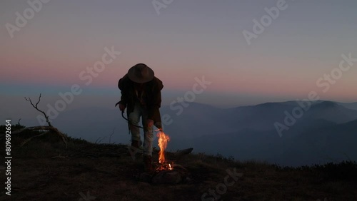 A swagman has a fire on top of a mountain in the Australian alps. photo