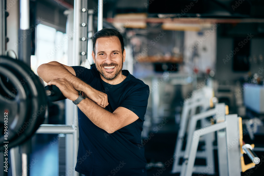 A male fitness instructor smiling for the camera, working at the gym, dressed in sportswear. A male fitness instructor smiling for the camera, working at the gym, dressed in sportswear.