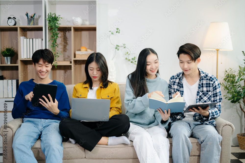 Group of young Asian college students working on his project assignment, using laptop computer and tablet an online informations. together, enjoy talking Group of young Asian college students working on his project assignment, using laptop computer and tablet an online informations. together, enjoy talking