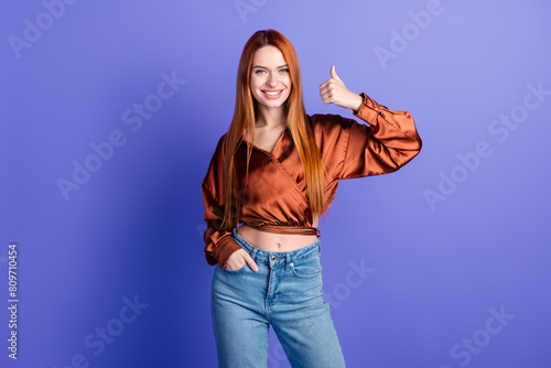 Photo of pretty young woman demonstrate thumb up wear brown shirt isolated on violet color background