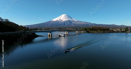 Speedboat Cruising At Lake Kawaguchi With Mt. Fuji In The Distance In Fujikawaguchiko, Yamanashi, Japan. - aerial shot photo