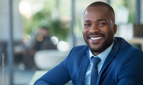 Smiling African American Businessman in Blue Suit at Modern Office photo