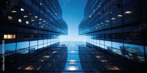 Fototapeta Naklejka Na Ścianę i Meble -  A city skyline with a blue sky and a few clouds. The buildings are tall and have many windows. The sky is clear and the sun is shining