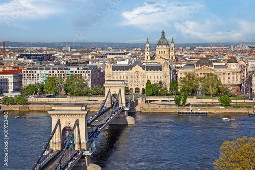 Panoramic view of Buda city as seen from Pest, with the chain bridge over Danube river and the cathedral of Saint Stephen, in Budapest, Hungary, Europe.  © YiannisMantas