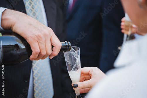 a man is pouring champagne into a glass
