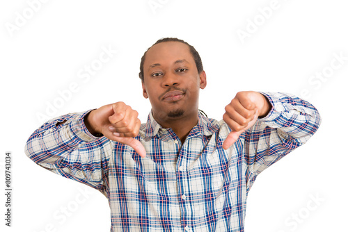 Closeup portrait, unhappy, angry, mad, pissed off man, annoyed, giving thumbs down gesture, looking with negative facial expression, disapproval, isolated on white 