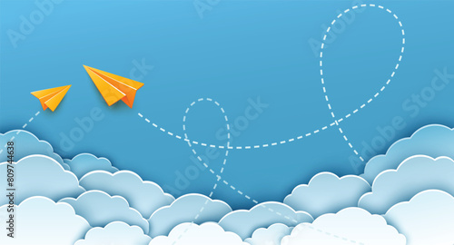 Two yellow origami paper plane with dash line track with loop in the