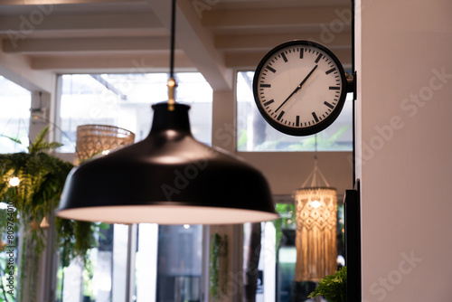 Clock hanging on the wall in the restaurant The decoration of the shop has a warm atmosphere