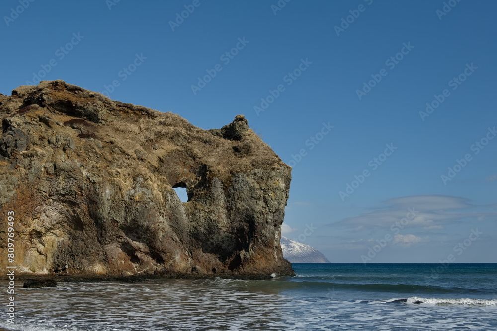 Russia. The Far East. The Kuril Islands. The picturesque rocky coast of Iturup Island in the Sea of Okhotsk. Russia. The Far East. The Kuril Islands. The picturesque rocky coast of Iturup Island in the Sea of Okhotsk.