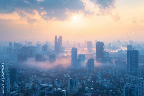 A city skyline with foggy clouds and a sun in the background. The city is covered in fog and the sun is barely visible
