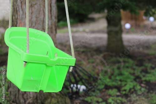 empty green outdoor plastic baby swing