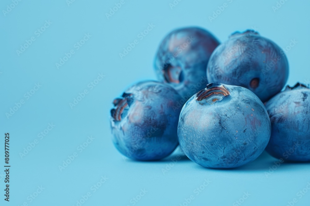 Obraz premium A visually captivating image of juicy blueberries with a soft focus background enhancing the textures on a blue surface