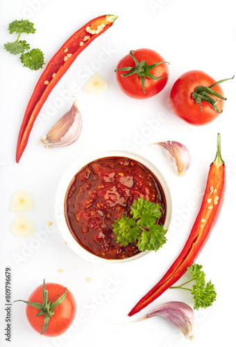 tomato sauce in a bowl adzika isolated on white background