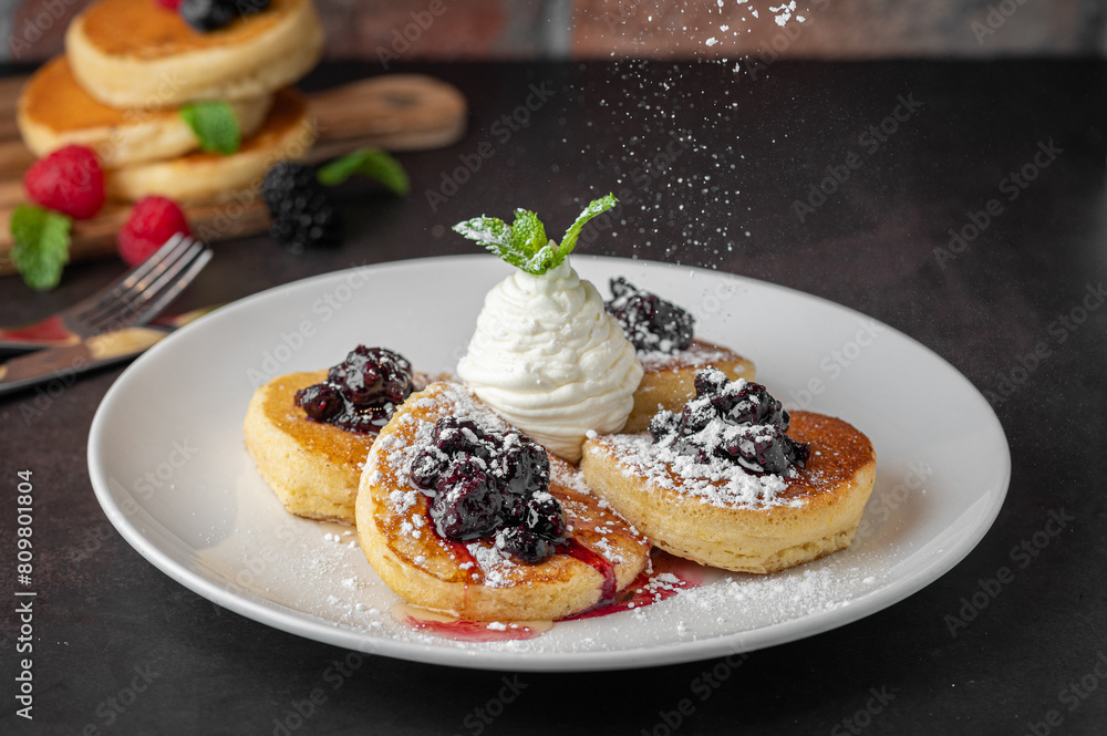 Fluffy pancakes topped with whipped cream and blackberries Fluffy pancakes topped with whipped cream and blackberries