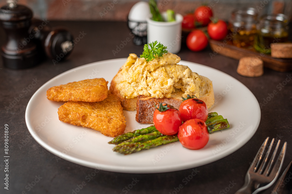 Plate of asparagus served with omelet and tomatoes