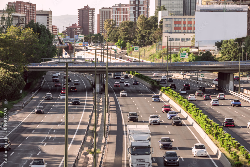 Obraz premium M30 urban ring road within the city of Madrid with several lanes in each direction and a multitude of large signs indicating directions and exits
