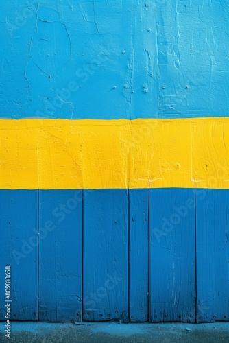 Vibrant, textured background featuring horizontal stripes of blue yellow paint on wooden surface. Visible cracks, chips, natural wood grain, ideal for projects needing rustic yet colorful backdrop