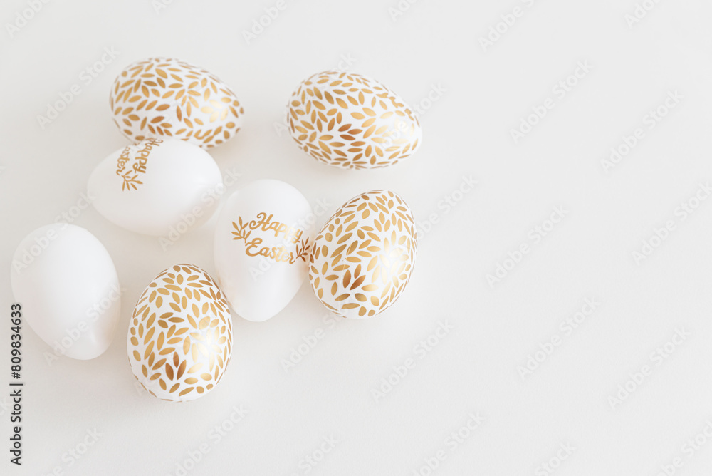 Golden Easter eggs on white background. Easter celebration concept. Flat lay. Top view Golden Easter eggs on white background. Easter celebration concept. Flat lay. Top view