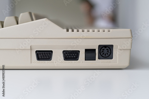 A side view of a vintage computer with visible ports, illuminated by daylight. Perfect for illustrating computer hardware, technology concepts, and connectivity.