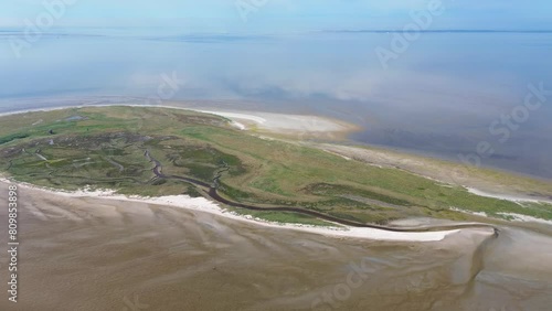 Aerial drone 4K film of the uninhabited island Griend, part of world heritage the Wadden Sea in the Netherlands. Bird sanctuary, protected site, dunes, tidal stream, beach and sand bank in reflection photo